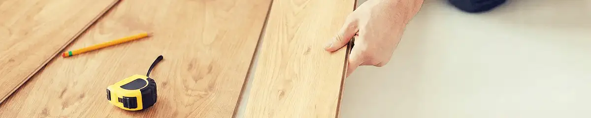 A professional installing wood flooring in Minneapolis, MN