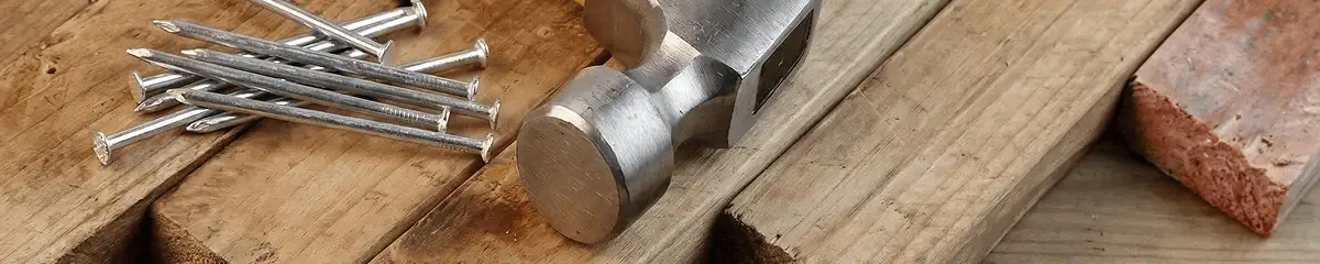 Hammer and nails on hardwood flooring boards in Minneapolis, MN