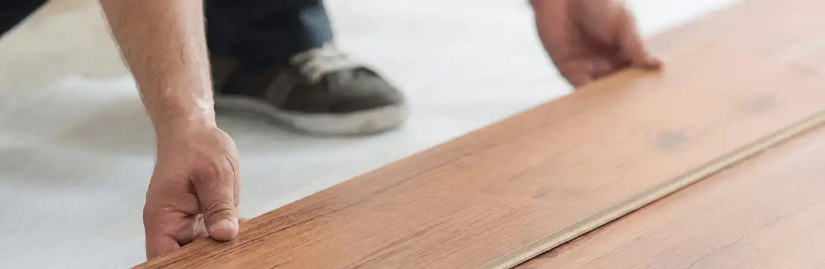 A professional installing laminate flooring in Minneapolis, MN